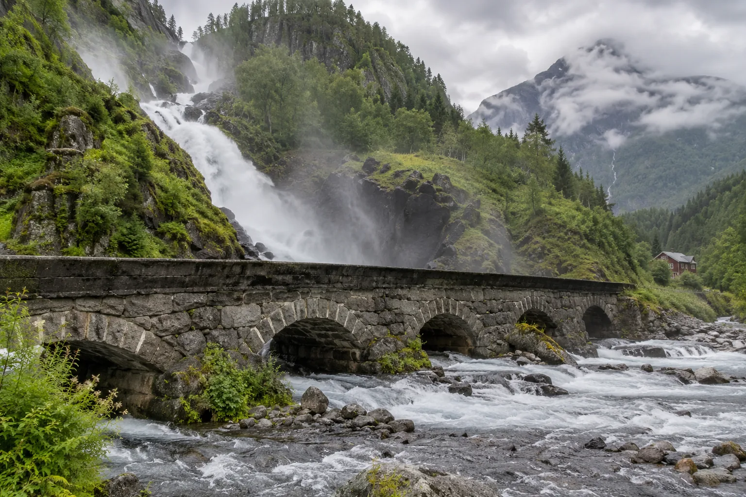 Puente de piedra junto a una cascada